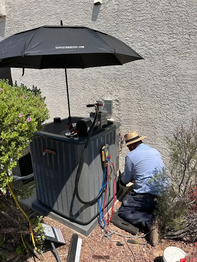 HVAC technician performing outdoor AC maintenance in Rolla